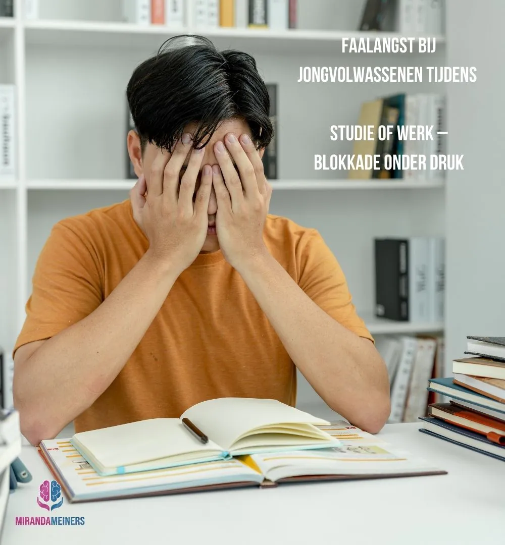 Jongvolwassene met faalangst zit aan bureau met boeken voor zich en handen voor het gezicht – zichtbaar geblokkeerd door prestatiedruk.
